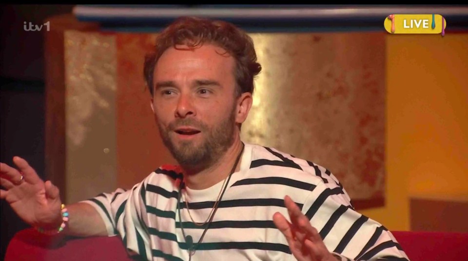 Man in striped shirt speaking on live television.