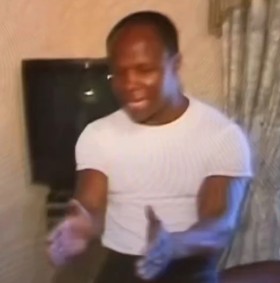 Man in white shirt gesturing.