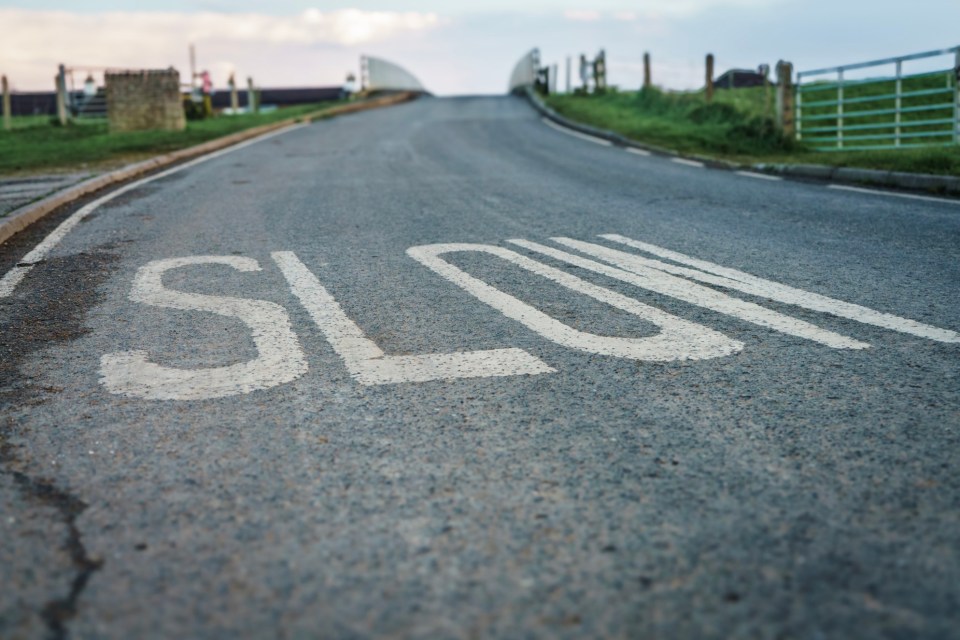 Pothole and Slow sign near Beal in North Yorkshire