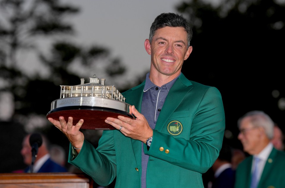 Rory McIlroy holding the Masters Championship trophy.