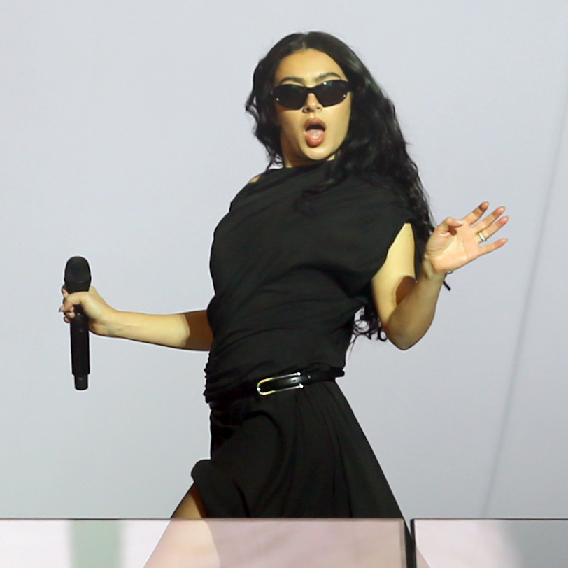 Charli XCX performing on stage.