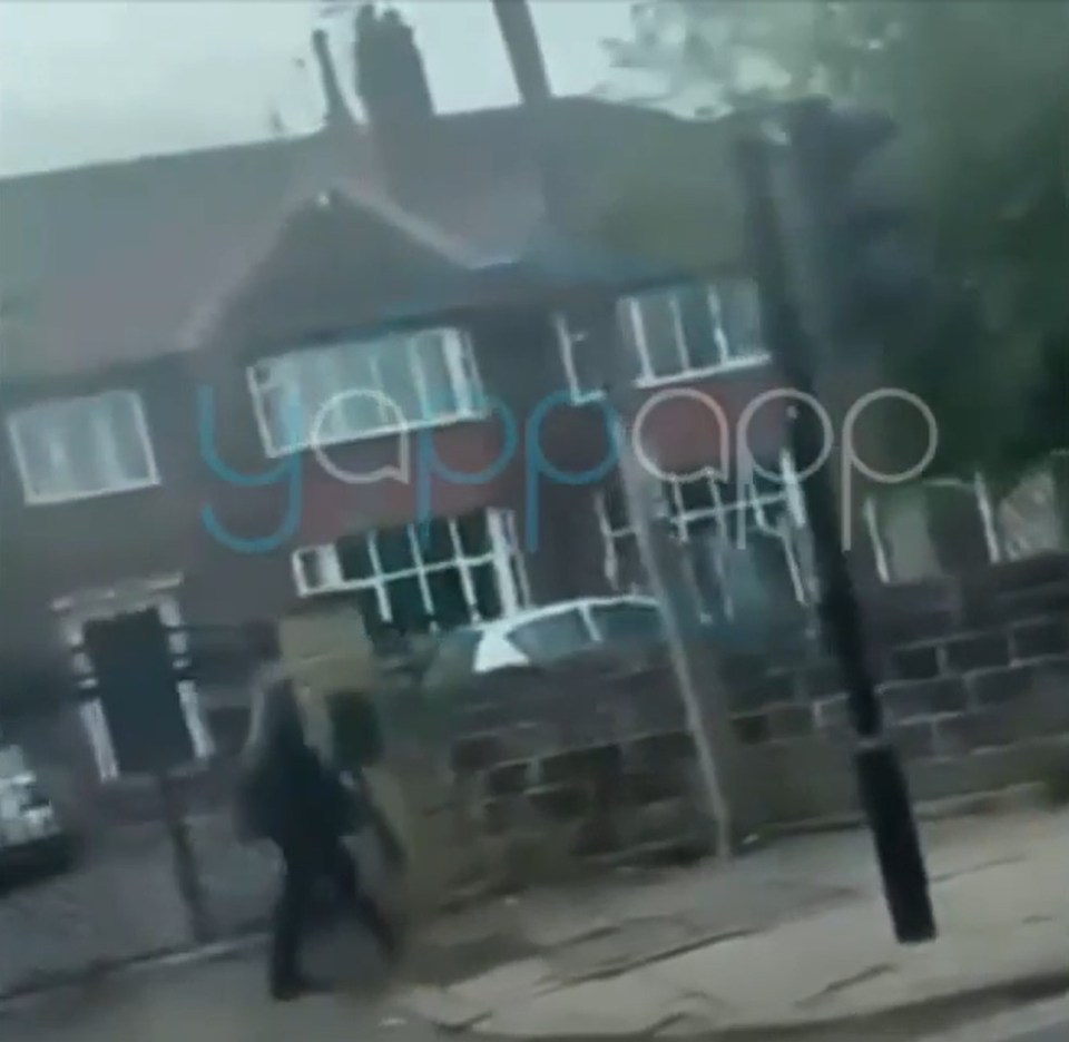 Person walking down a street in Leeds, UK.