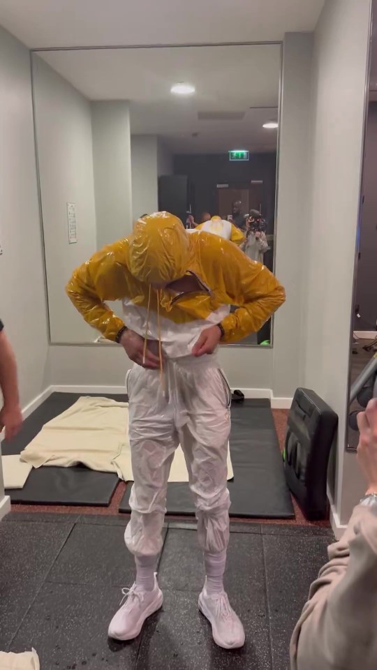 Chris Eubank Jr. sweating in a yellow jacket and white pants.