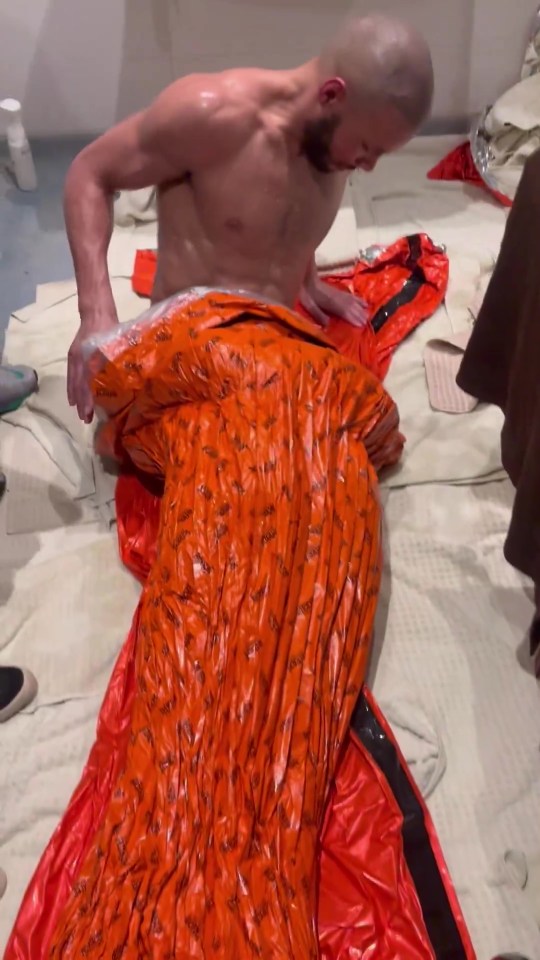 Chris Eubank Jr. wrapping himself in an orange sweat wrap.