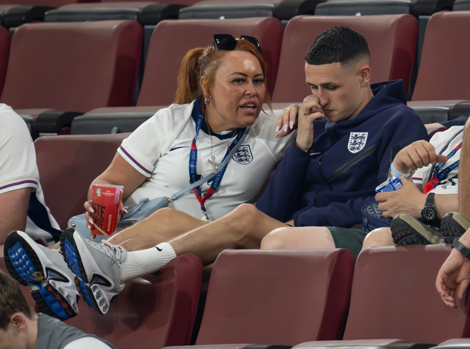 Phil Foden with his mother in the stands after a game.