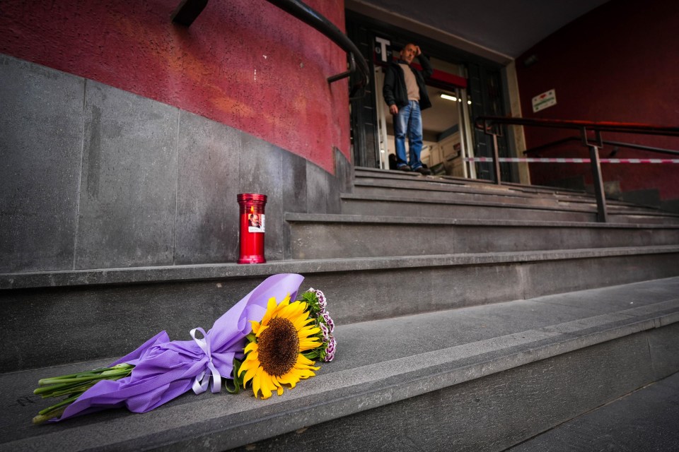 Flowers and a candle left on steps near the site of a cable car accident.