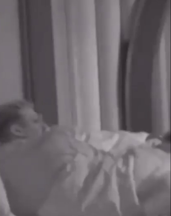 Screenshot of a person lying in bed.