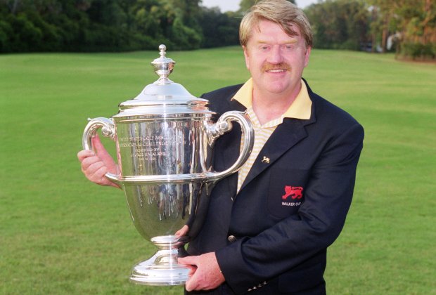 Peter McEvoy holding the Walker Cup trophy.