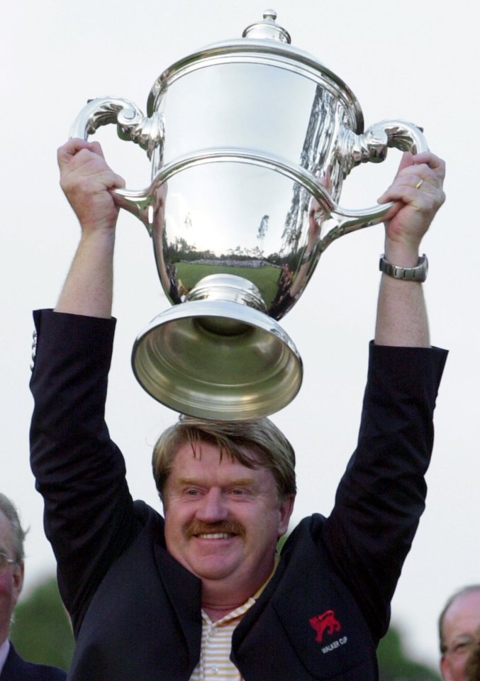 Peter McEvoy holding the Walker Cup aloft.
