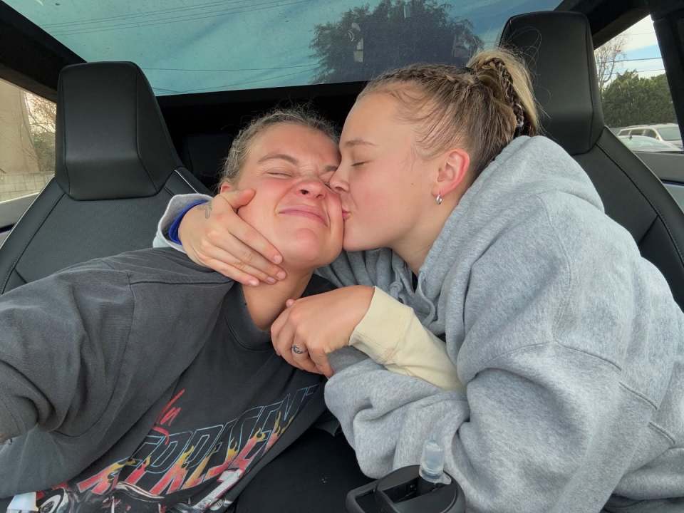 Two women embracing in a car.