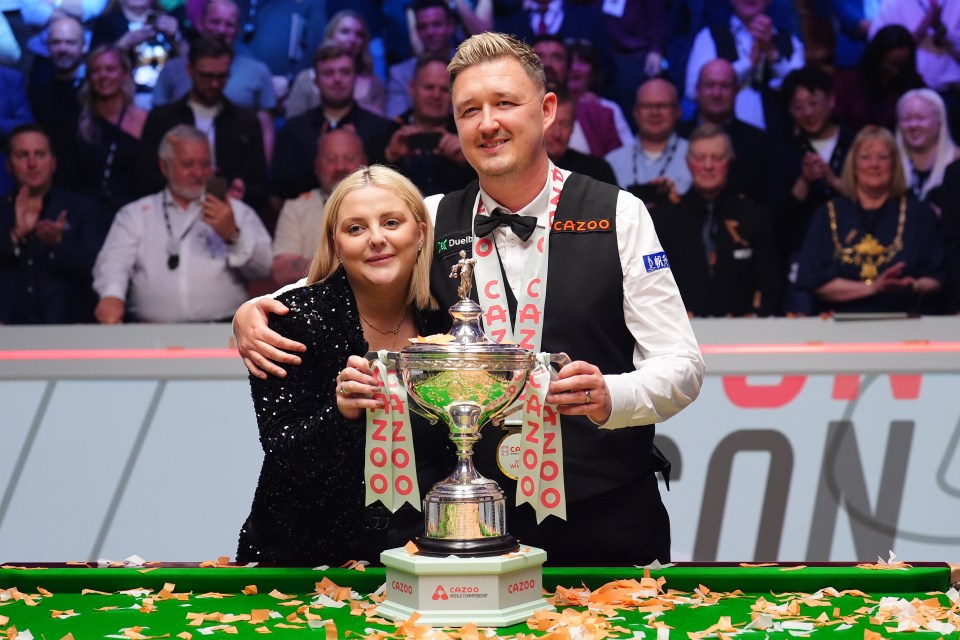 Kyren Wilson and his wife Sophie Lauren celebrating a snooker championship win.