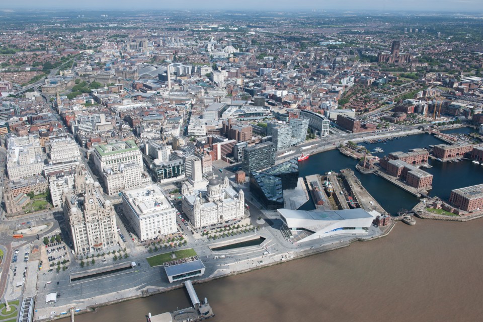 Aerial view of Liverpool's waterfront, including the Royal Albert Dock and city center.