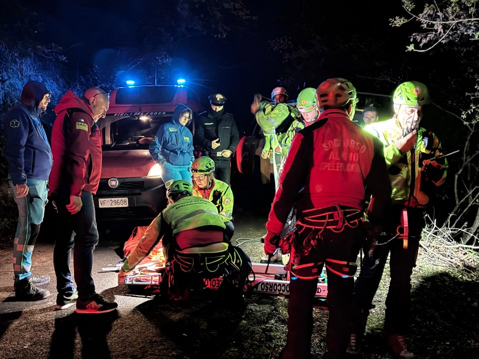 Emergency responders attending to injured tourists at a cable car accident site.