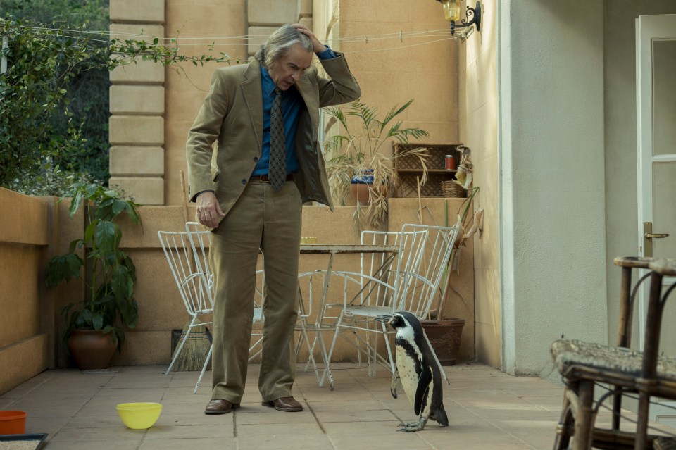 Film still of Steve Coogan as Tom Michell with a penguin.