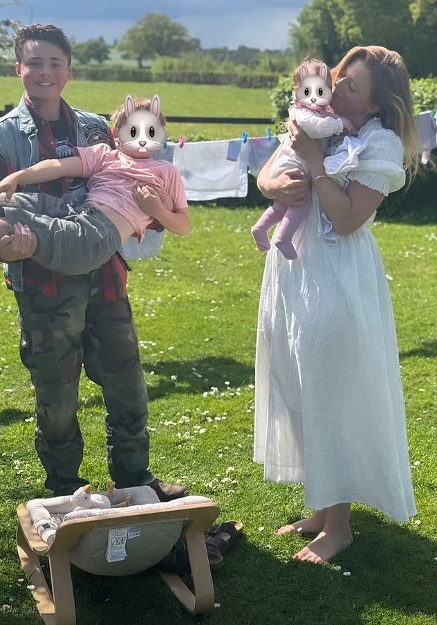 A woman and her children in a garden.