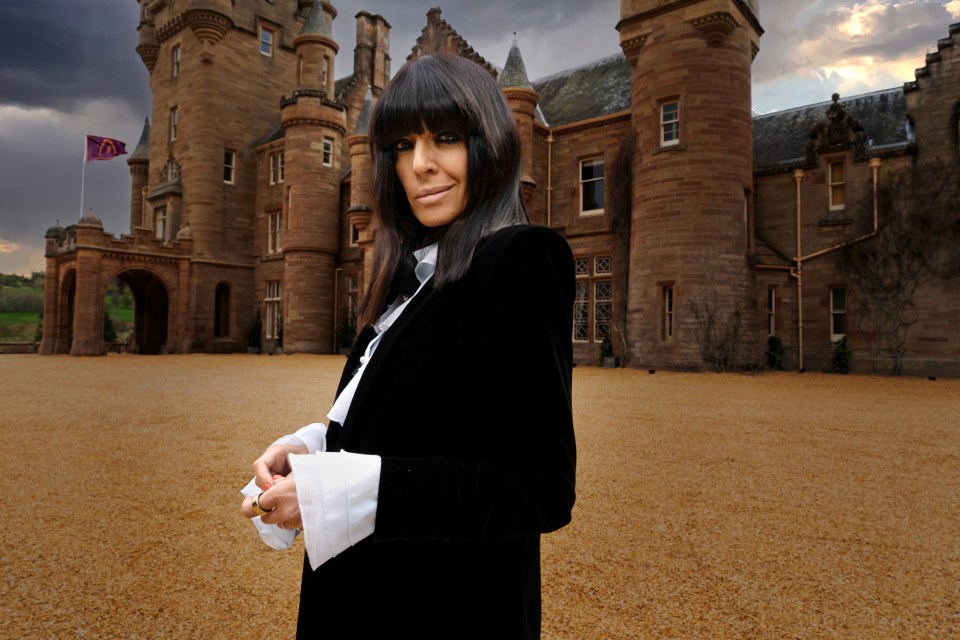 Claudia Winkleman standing in front of a castle.