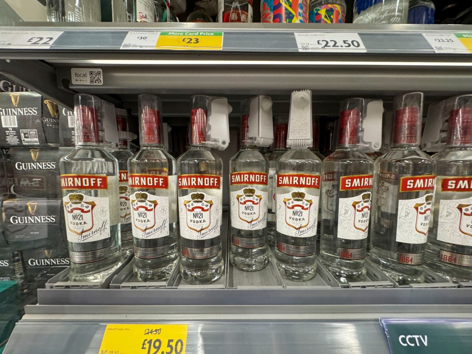 Smirnoff vodka bottles on a supermarket shelf.