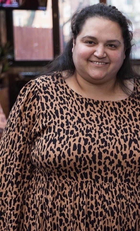 Portrait of Amy Kane, wearing a leopard-print dress.