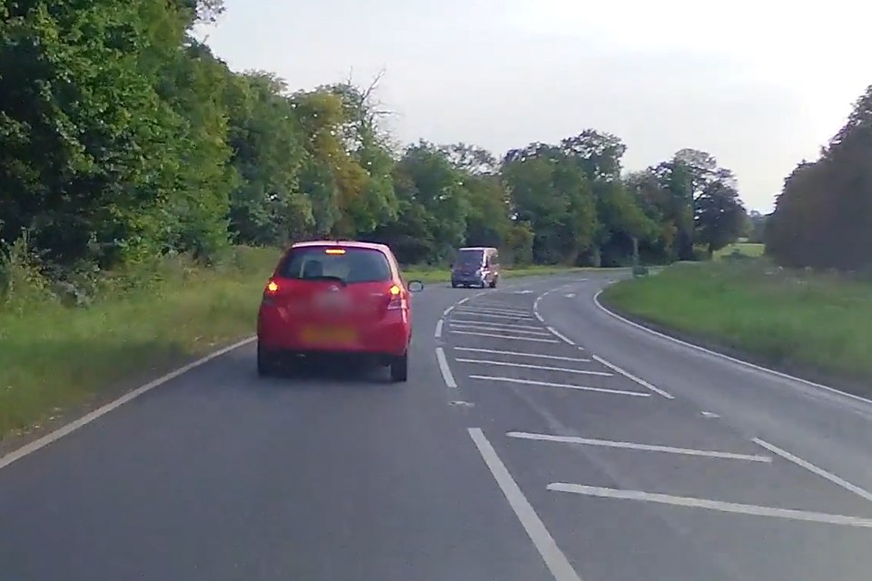 Dashcam footage of a minibus colliding with oncoming traffic.