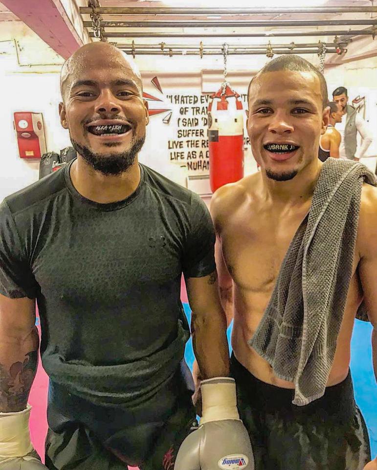 Chris Eubank Jr. and Sebastian Eubank in a boxing gym.