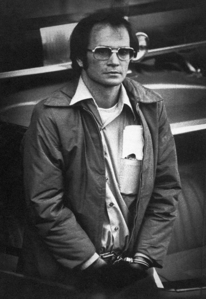 Black and white photo of James W. Lewis in handcuffs.
