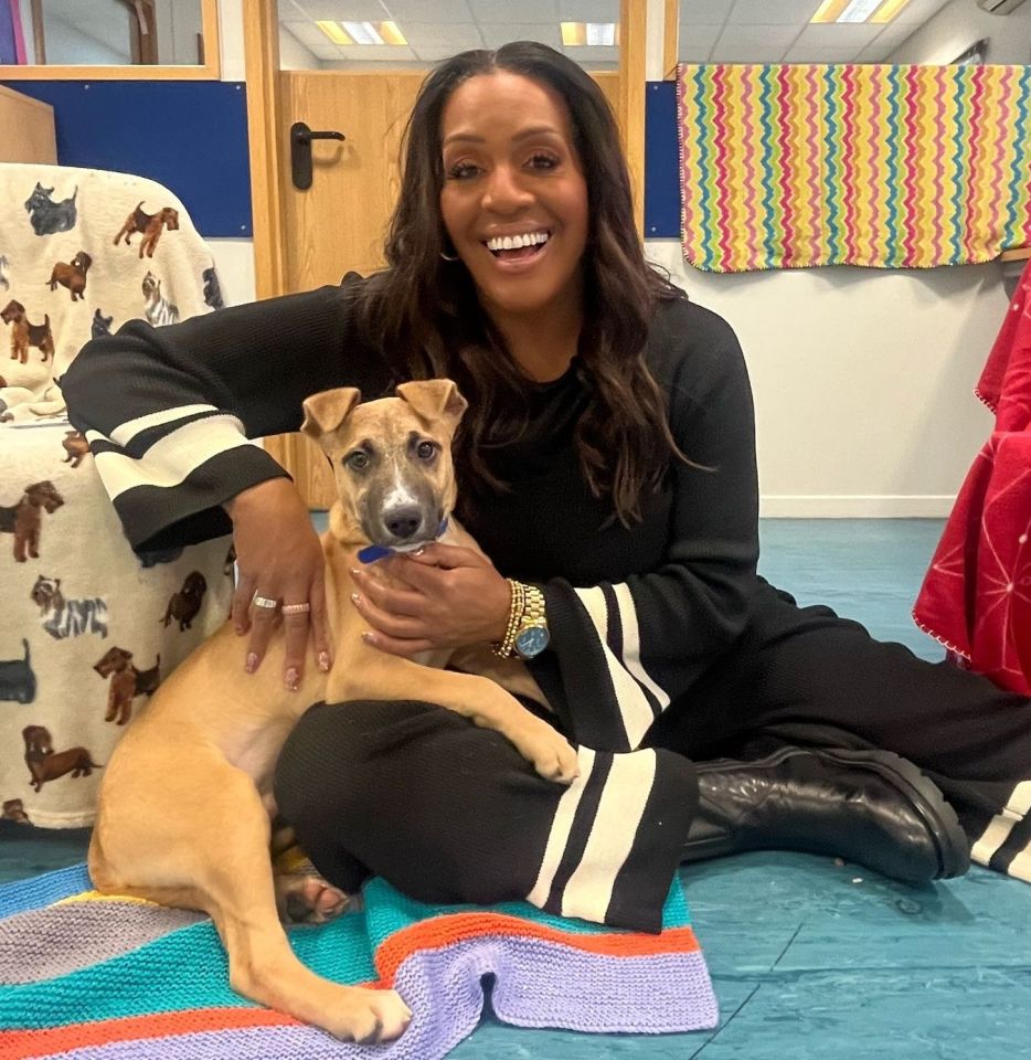 Alison Hammond holding a tan puppy.