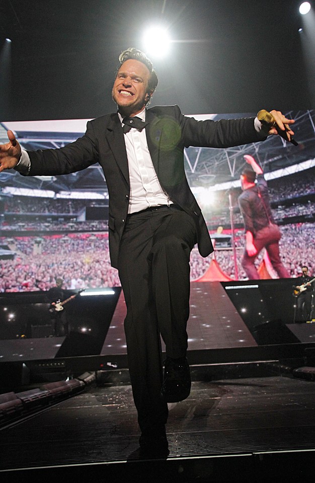 Olly Murs performing on stage at a sold-out concert.