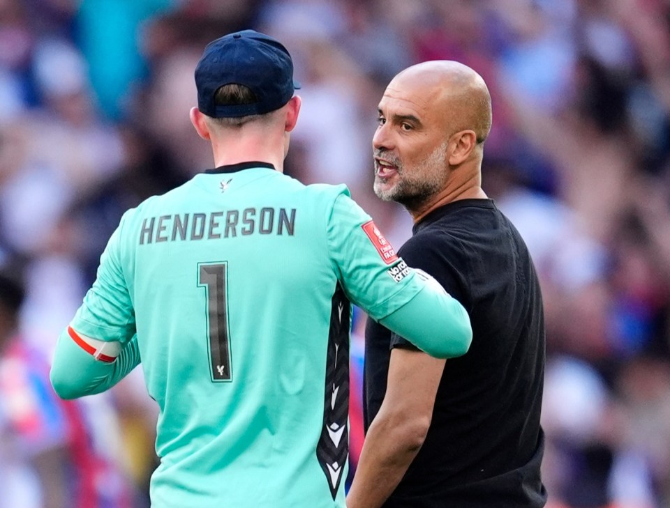 Dean Henderson and Pep Guardiola talking on a soccer field.