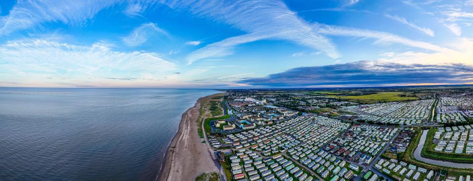 Aerial panoramic view of Ingoldmells, UK seaside at sunset.