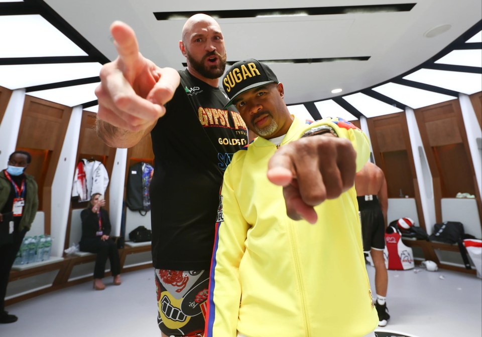 Tyson Fury and his trainer SugarHill Steward pointing at the camera.