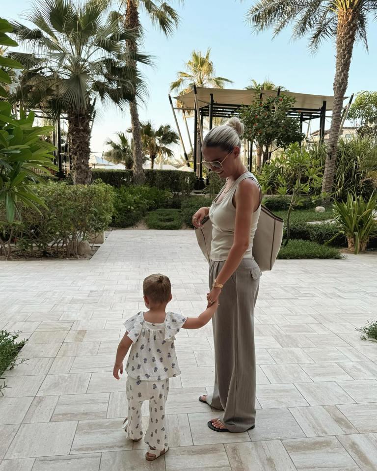 Woman and toddler holding hands in Dubai.