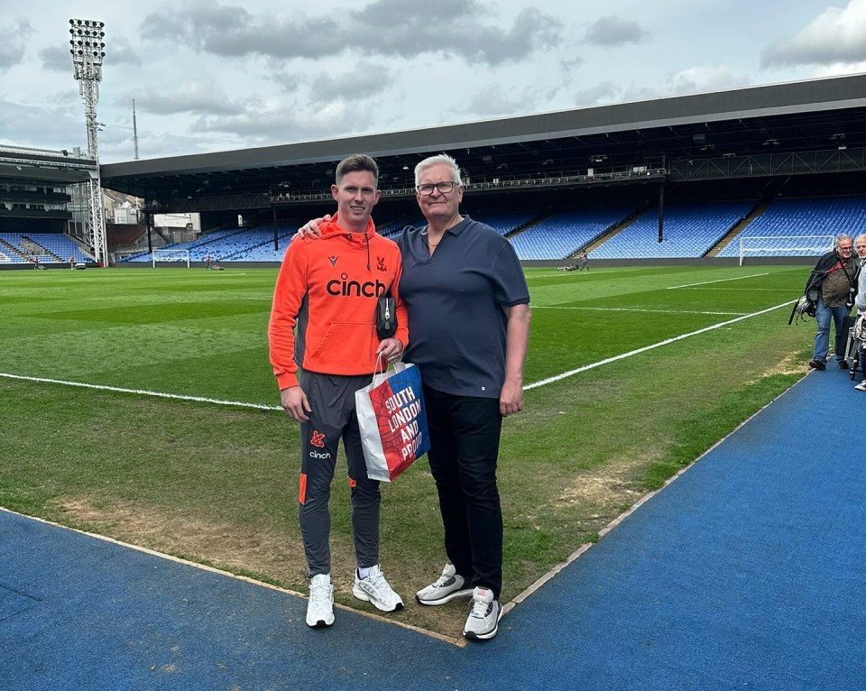 Dean Henderson with his father at a soccer stadium.