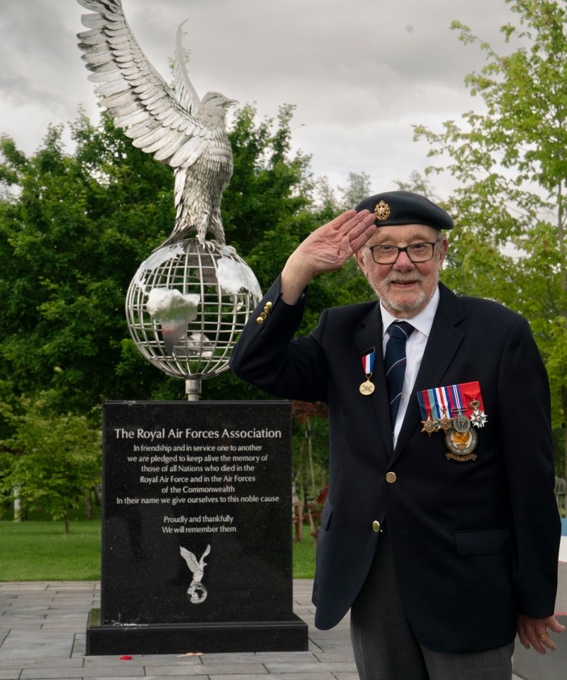 D-Day veteran saluting at the Royal Air Force Association memorial.