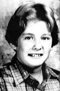 Black and white photo of a smiling boy.