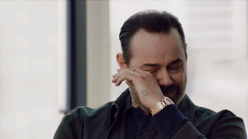 Man wiping away tears.