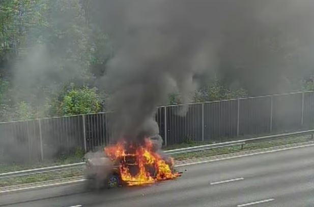 Car on fire on a highway.