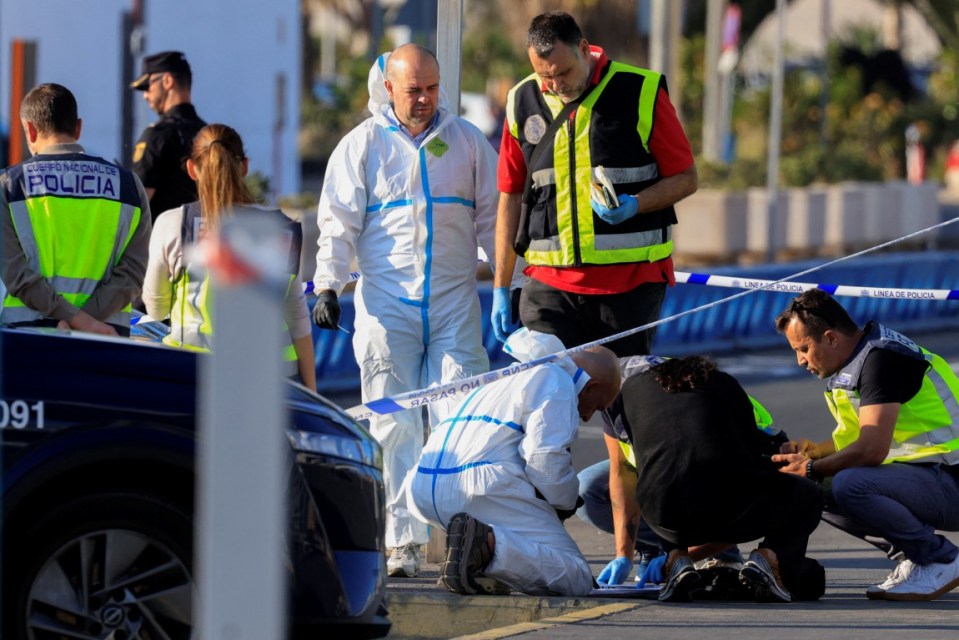 Spanish National Police officers examine documents belonging to a man who was shot and killed by police during an intervention, outside Gran Canaria Airport, in Telde, Spain, May 17, 2025. REUTERS/Borja Suarez