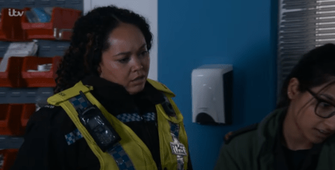 Screenshot of a police officer speaking to a person.