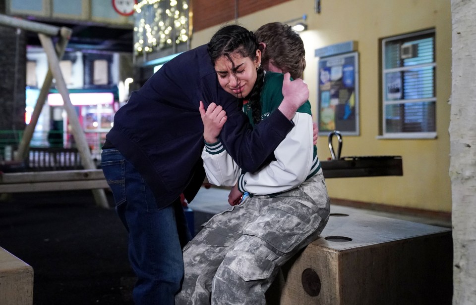 Avani Nandra-Hart crying and being comforted by Barney Mitchell in an EastEnders scene.