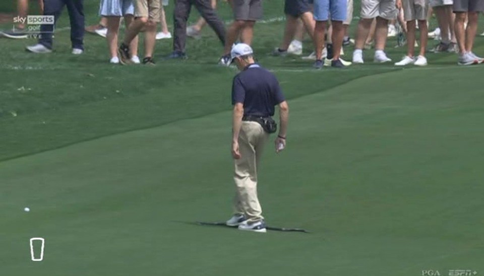 Golfer walking away from the green.