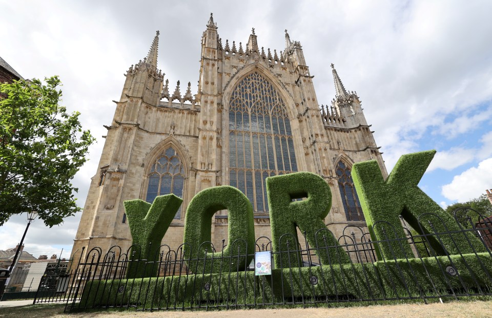 York Minster with large, artificial turf letters spelling "YORK" in the foreground.