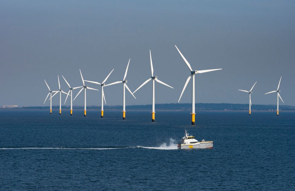 Offshore wind farm with a supply vessel.