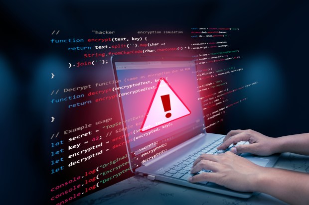 Illustration of a laptop displaying a warning sign over code, with hands typing.