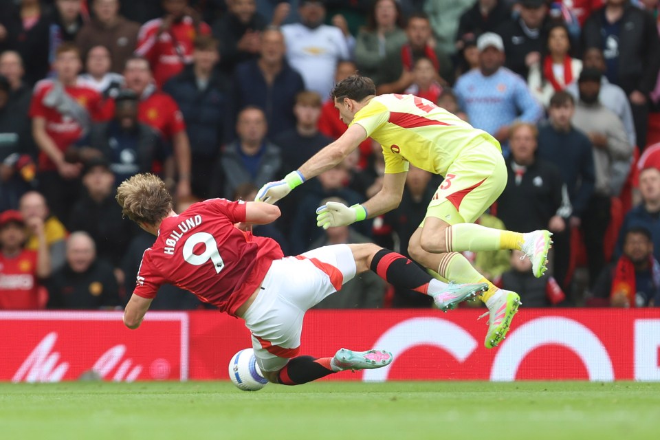 Emiliano Martinez of Aston Villa fouling Rasmus Hojland of Manchester United.