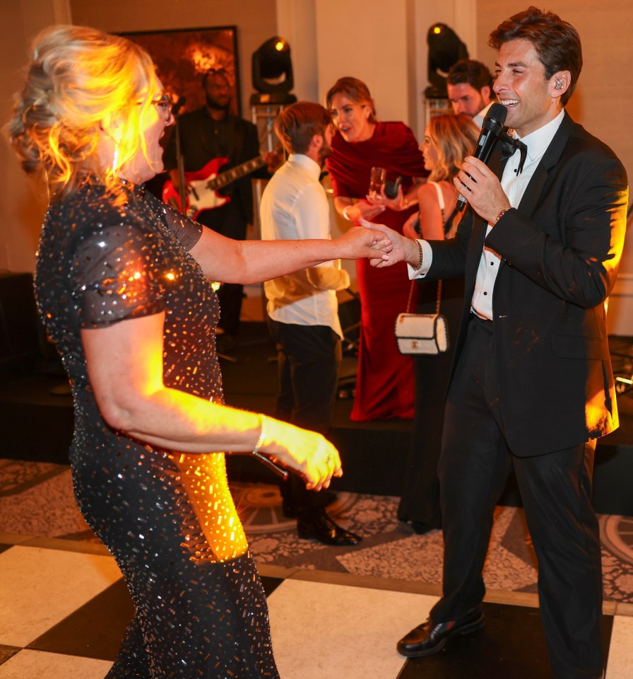 James Argent singing at a charity event.