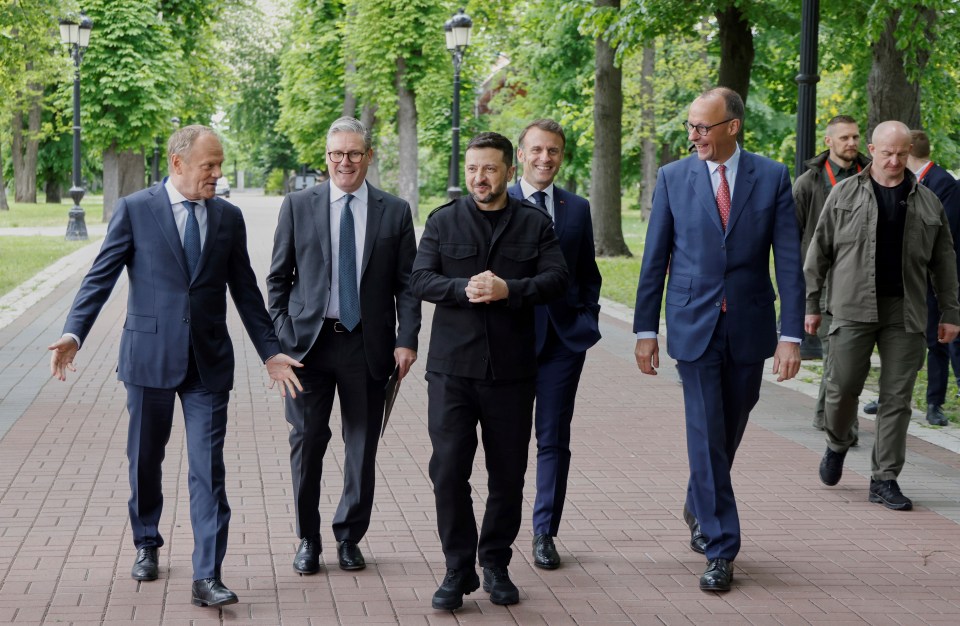 Five world leaders walking together.
