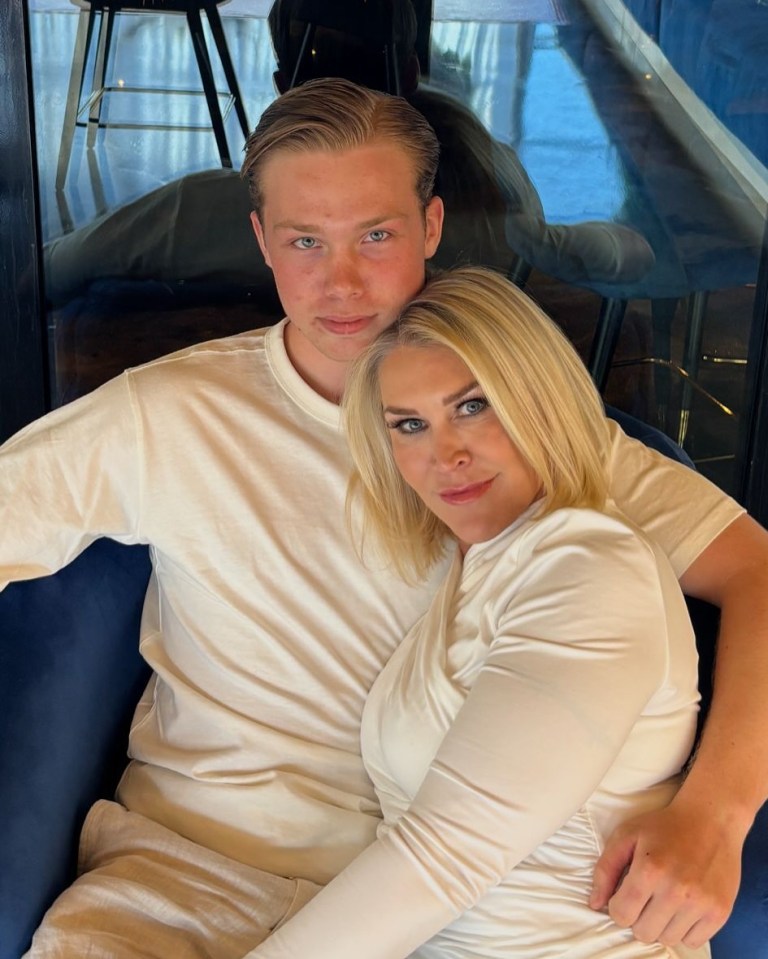 A mother and son embracing.