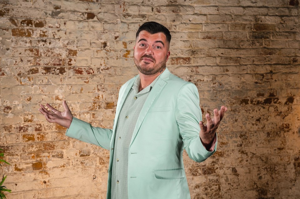 Luke Worley in a light green suit, gesturing with his hands.