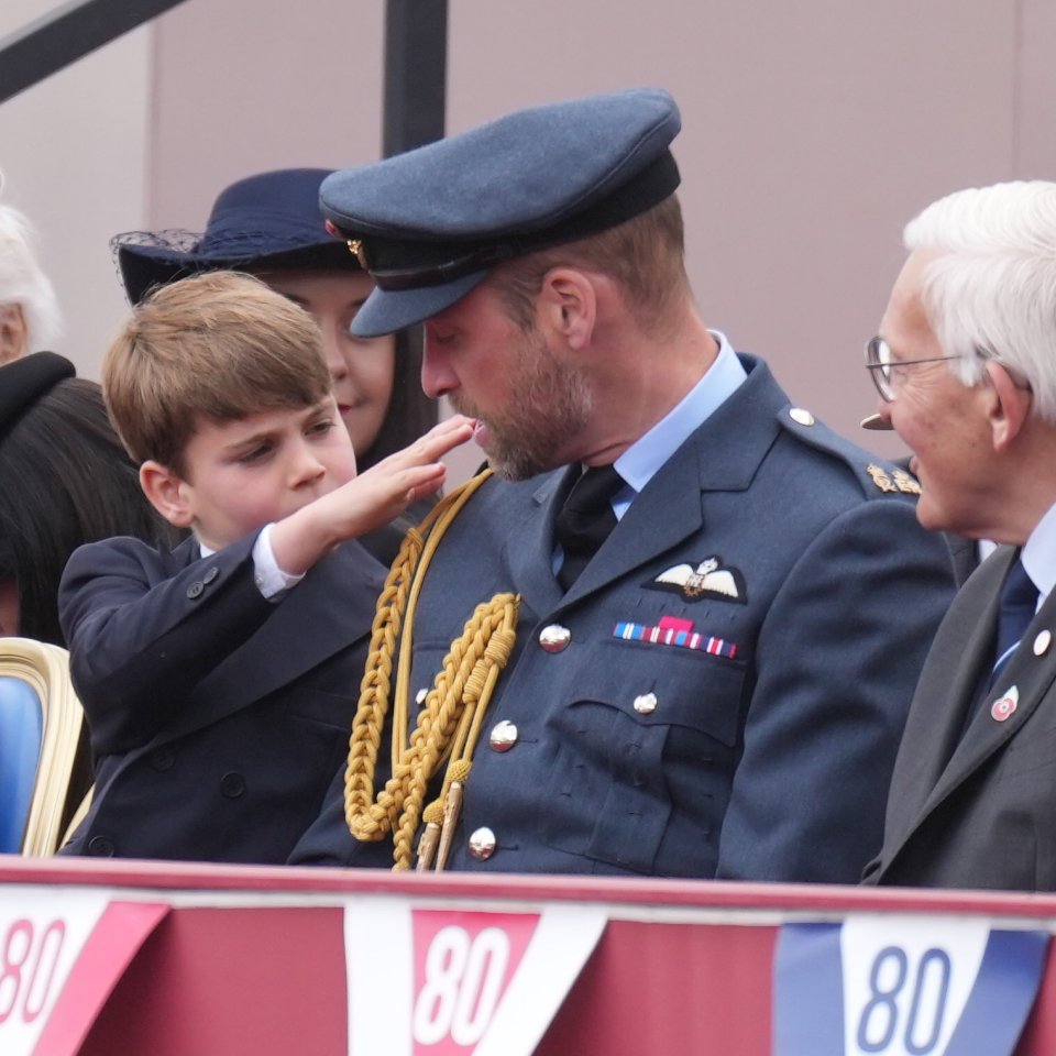 A young boy salutes a member of the Royal Family in military uniform at a VE80 celebration.