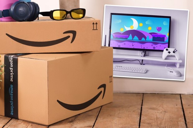 Amazon Prime boxes next to a computer setup with a game displayed on the monitor.